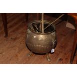 Brass coal bucket on three hoofed feet with fire place accessories.