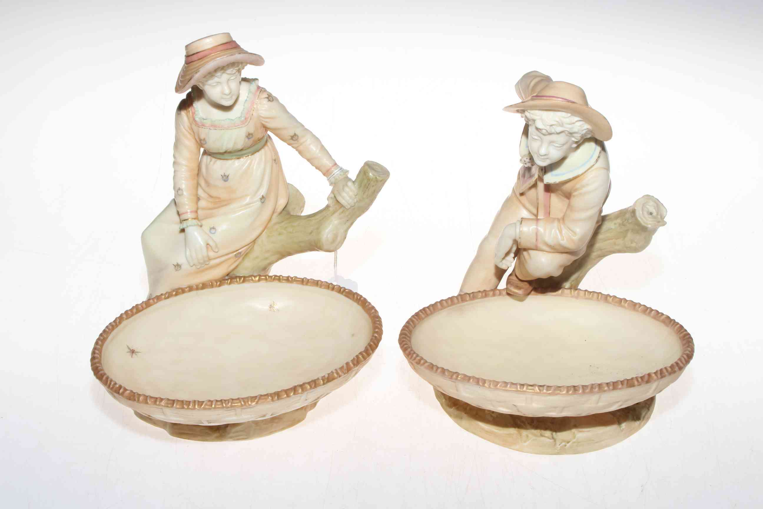 Pair Royal Worcester Hadley figure tazza, boy and girl with basket resting,