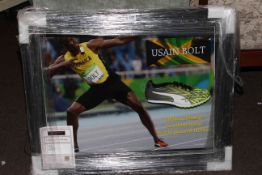 Framed running shoe signed by Usain Bolt with Certificate of Authenticity.