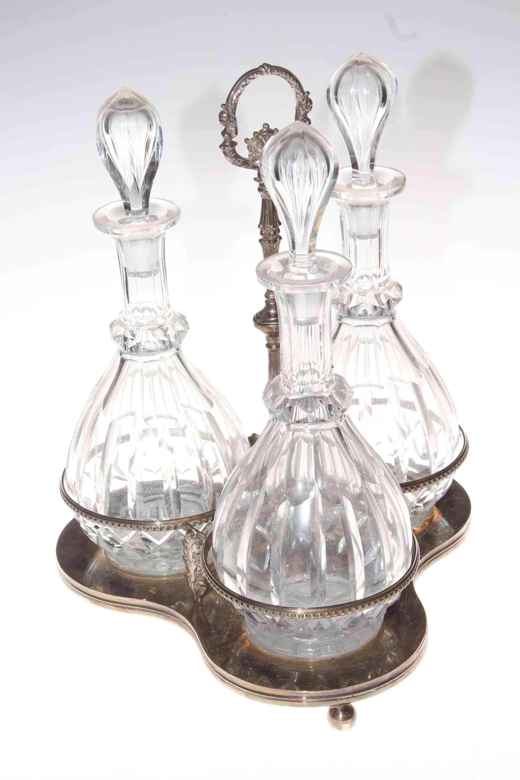 Silver plated decanter stand with three glass decanter bottles, 40cm high.