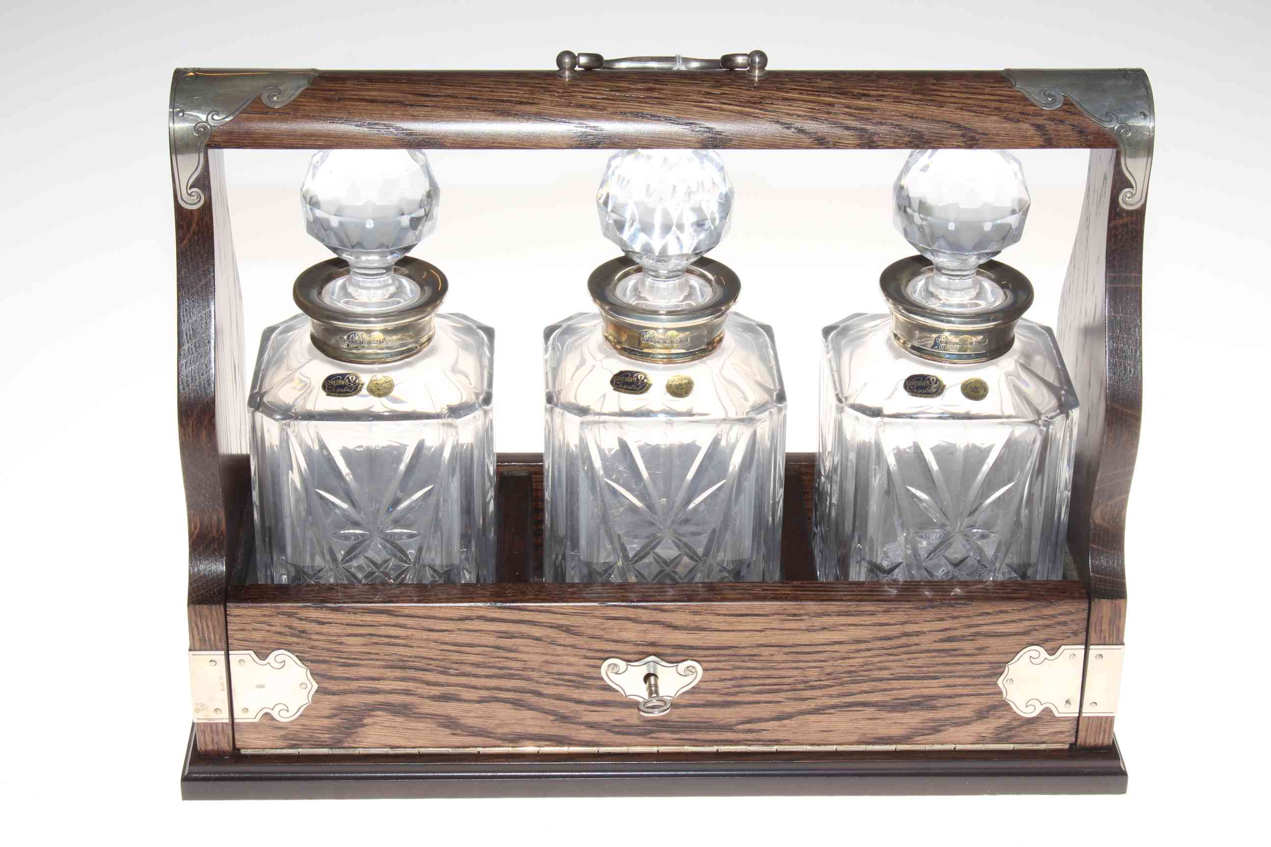 Oak and silver mounted tantalus with three silver collared Bohemia Crystal decanters, 40cm by 30cm.