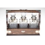 Oak and silver mounted tantalus with three silver collared Bohemia Crystal decanters, 40cm by 30cm.