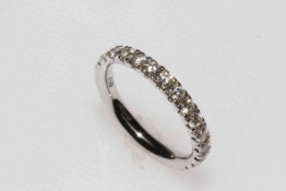 Diamond half eternity ring set in 18 carat white gold and having fifteen brilliant cut diamonds,