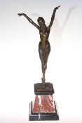 Art Deco style bronze lady figure in a dancing pose on marble plinth, 56cm high.