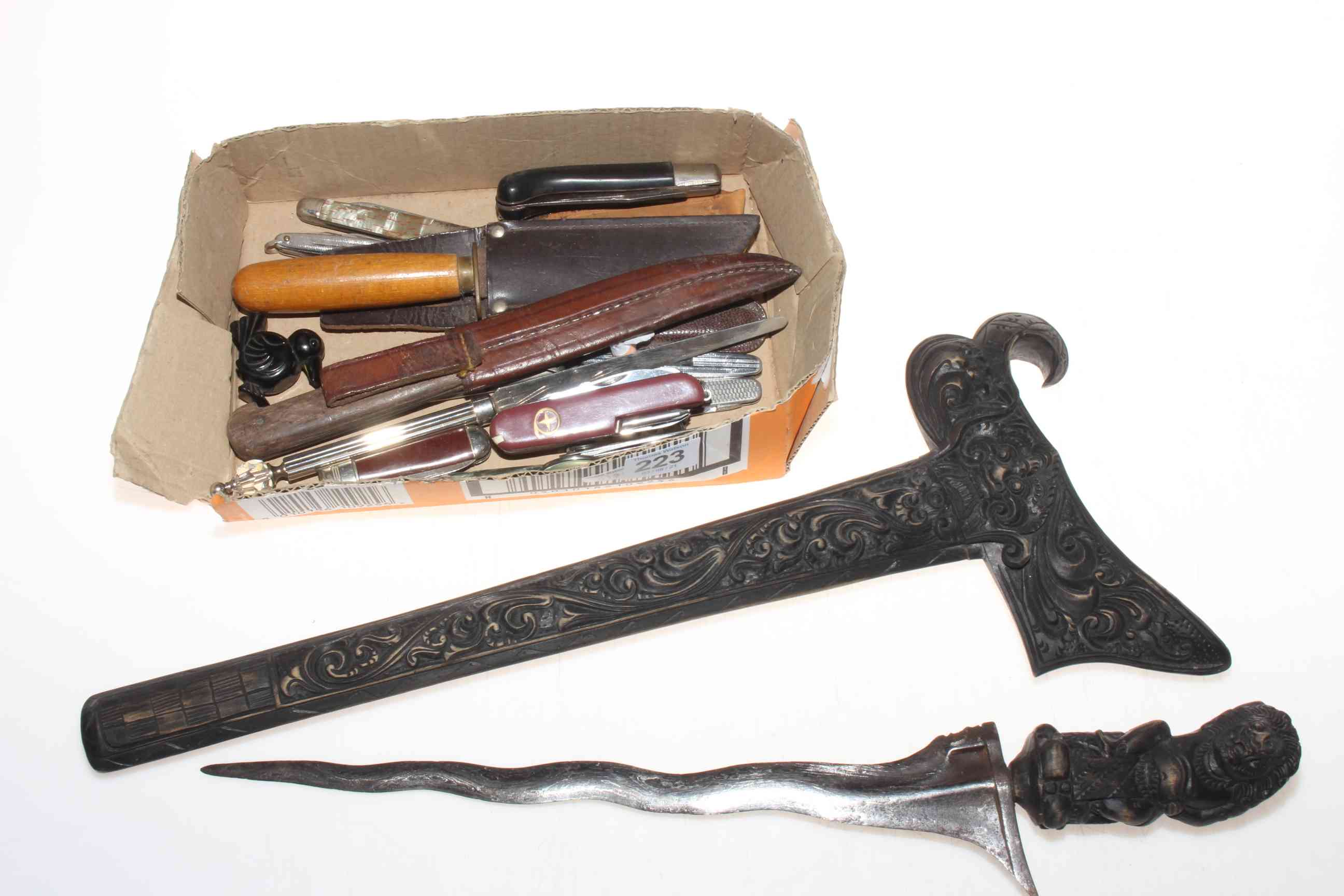 Box of knives and carved dagger.