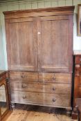Victorian oak press having two panelled doors above four drawers on turned legs,
