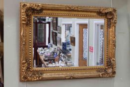Gilt framed rectangular bevelled wall mirror, 120cm by 89cm overall.
