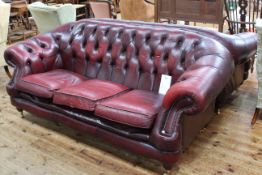 Pair deep buttoned ox blood leather three seater Chesterfield settees.