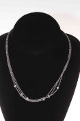 18 carat white gold 'by the yard' chain set with six diamonds.