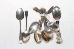 Collection of various silver teaspoons.