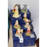 Disney Showcase by Royal Doulton, eight pieces comprising Snow White, five Dwarfs, Tramp and Lady.