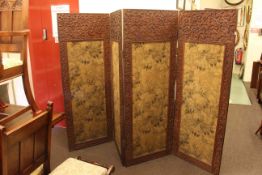 Ornately carved wood four fold vanity screen with tapestry panels, 166cm high.