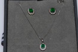 18k white gold, emerald and diamond pendant and chain, together with a pair of earrings.