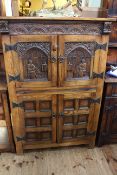 Carved oak four door drinks cabinet, 125cm high by 83cm wide by 47cm deep.