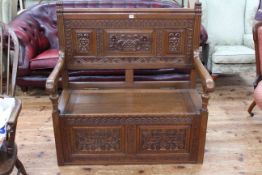 Carved oak box hall bench, 110cm high by 107cm wide by 56cm deep.