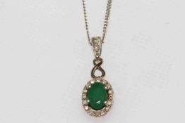 9 carat gold, emerald and diamond pendant with silver chain.