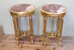 Pair circular gilt and inset marble topped lamp tables, 72cm high by 47cm diameter.