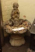 Weathered figure of Pan and shell pedestal bird bath.