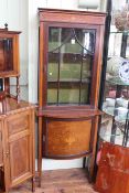 Edwardian inlaid mahogany cabinet having glazed panel door top above a bow front cupboard on square