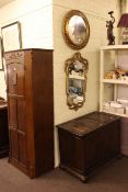 Oak hall wardrobe, carved oak blanket box and two gilt framed wall mirrors (4).