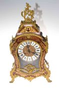 Ornate Boulle style mantel clock with enamelled Roman numerals.