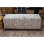 Late 19th Century ottoman in floral tapestry fabric, 50cm high by 138cm wide by 49cm deep.