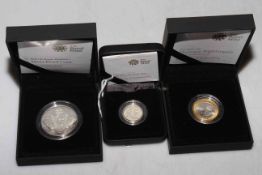 Three silver proof Royal Mint coins in boxes with COAs.