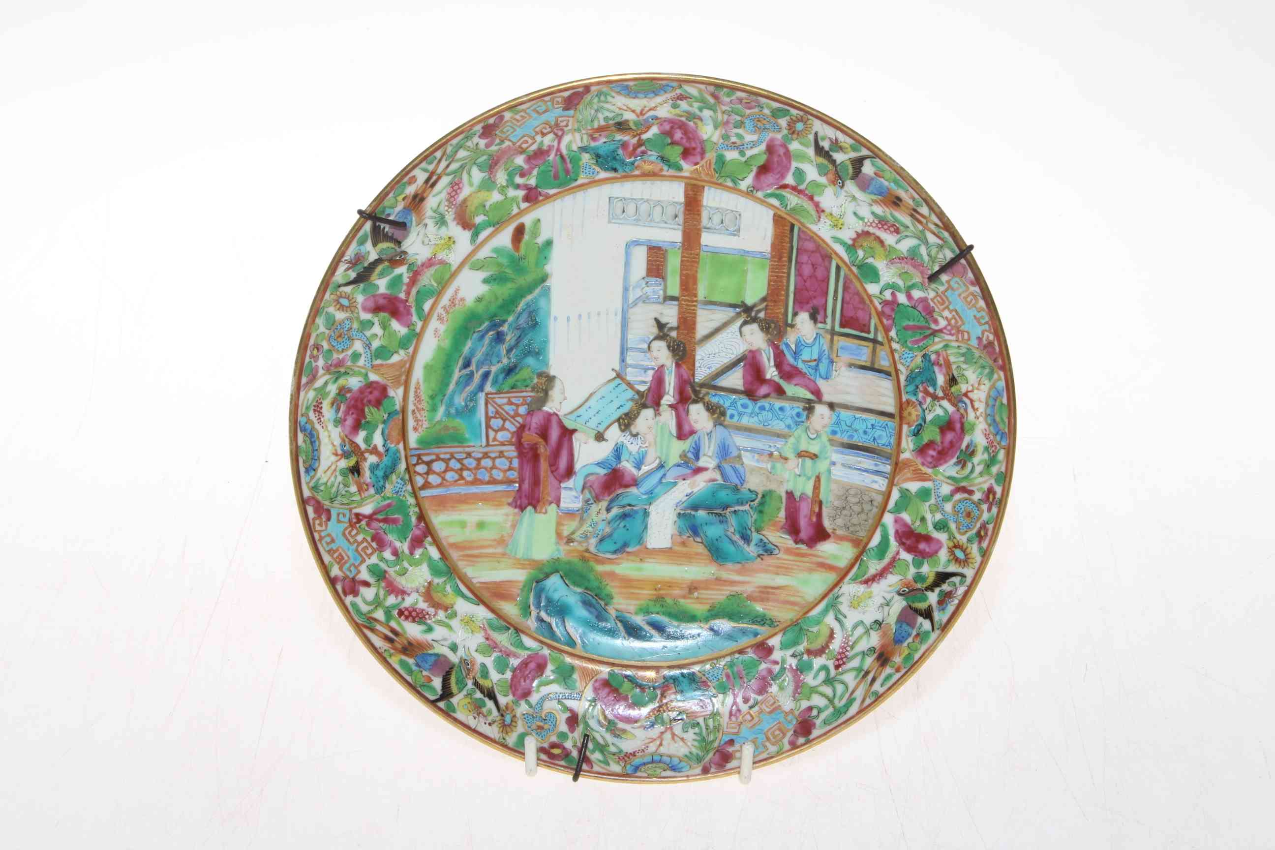 Small Canton plate, well painted with figures and bird and foliate border, 21.5cm diameter.
