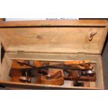 Tool box containing seven planes and saw (box 30cm by 85cm by 29cm).