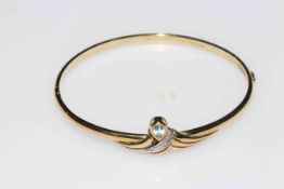 9 carat gold bangle set with aqua drop and three tiny diamonds, 6.5cm across.