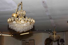 Pair of gilt metal ceiling lights with tiered glass lustre drops.