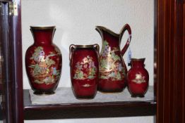 Four pieces of Crown Devon Rouge Ware decorated with Oriental scenes.