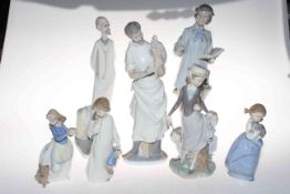 Four Lladro and three Nao figurines.