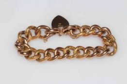 9 carat gold chain link bracelet with chased links and padlock fastener.