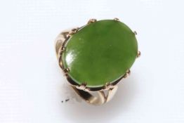 Gold green jade ring, with large oval stone, 20mm by 15mm, size N.