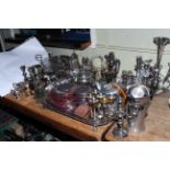 Collection of silver plated wares including teapots, cutlery, candelabra, serving tray.