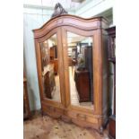 Oak arched top armoire having two mirror panelled doors above two drawers,