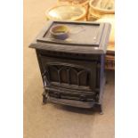 Cast wood burning stove, 72cm high by 58cm wide by 44cm deep.