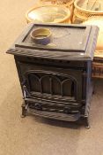 Cast wood burning stove, 72cm high by 58cm wide by 44cm deep.