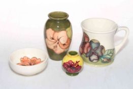 Four Moorcroft Pottery pieces, cup, two vases and a dish.