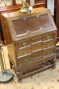 Early 20th Century oak three drawer bureau, the fall front drawing fitted interior,