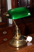 Brass desk lamp with green glass shade.