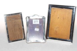 Three small silver easel photograph frames.