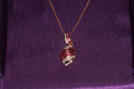 14k gold ruby and diamond pendant and chain.