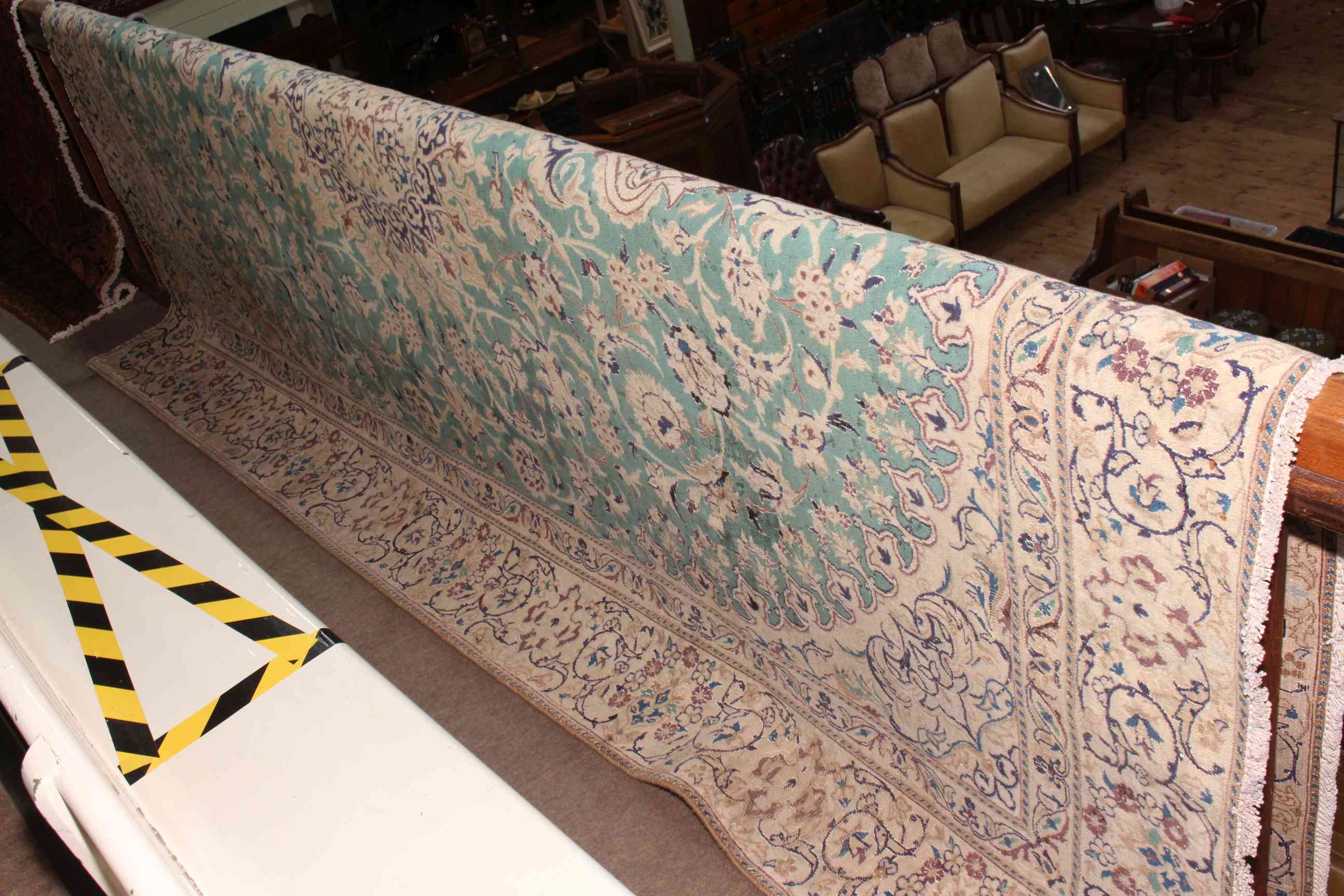 Fine hand made green ground Iranian carpet from the Naeen region 325 by 220cm.