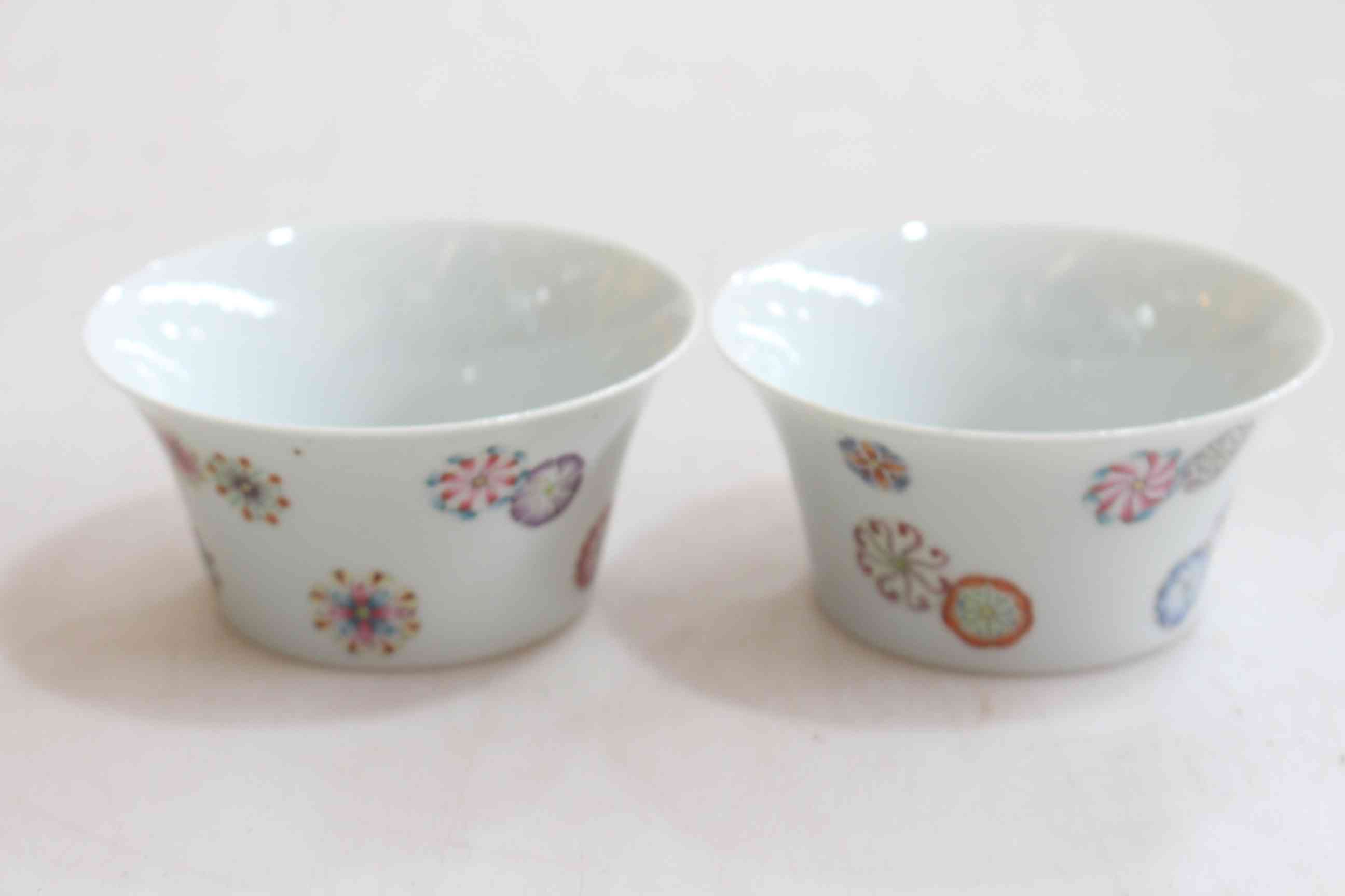 Pair Chinese tea bowls with 'floating roundels' decoration.