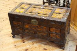 Heavily carved Camphor wood box with light stained panels, 89 by 43cm.