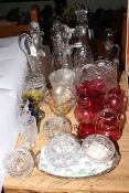 Collection of glasswares including ruby glass, decanters and ewers, powder bowls, vases, etc.