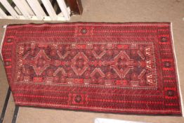 Red ground hand made Baluchi rug 200 by 120cm.