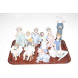 Collection of ten Lladro figures including clown with puppy, rocking chair, and Spanish girl.